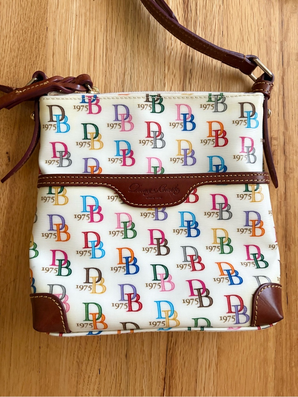 Dooney and Bourke 1975 signature logo cream coated canvas crossbody purse y2k